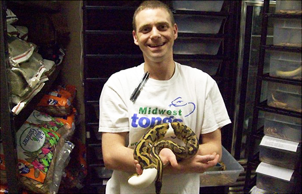 Jared Ohsman smiling and holding a piebald ball python